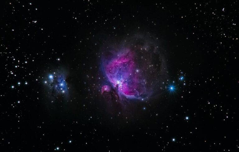 Amateur astronomer observing night sky through refractor telescope on tripod