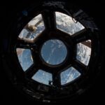 Astronaut conducting extravehicular activity in deep orbit