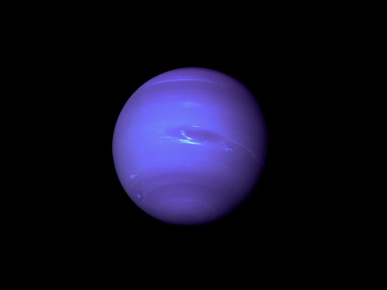 Gas giant planet bands and celestial moons visible through telescope optics